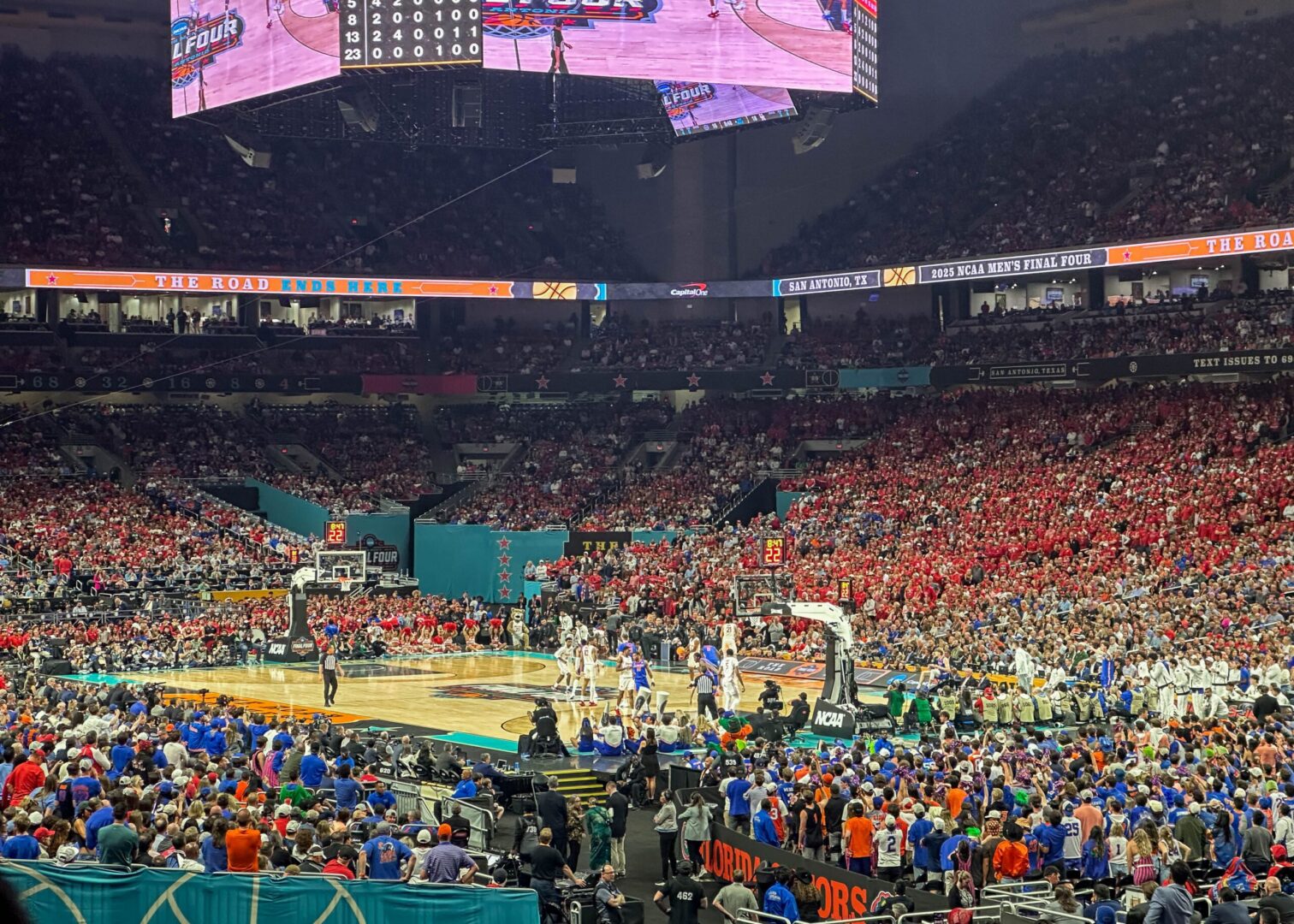 Basketball game in crowded indoor stadium.