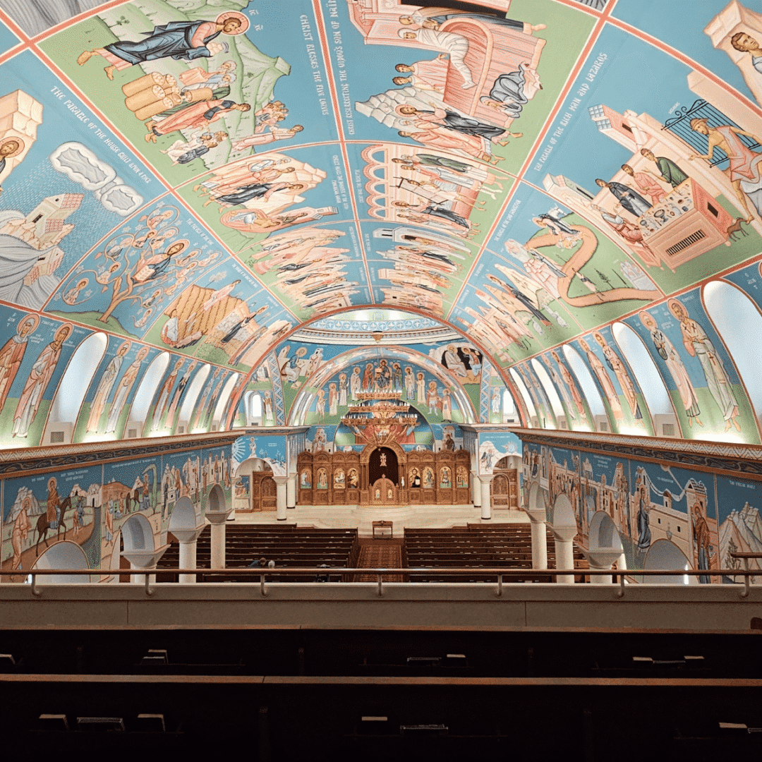 Colorful church interior with detailed ceiling murals.