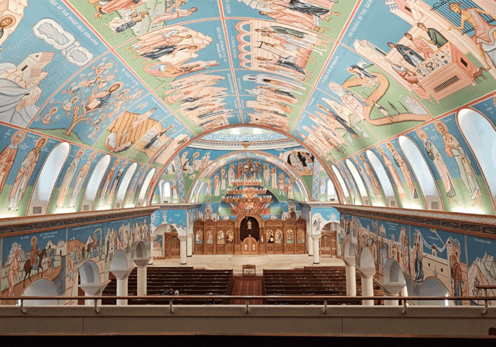 Colorful church interior with detailed ceiling murals.